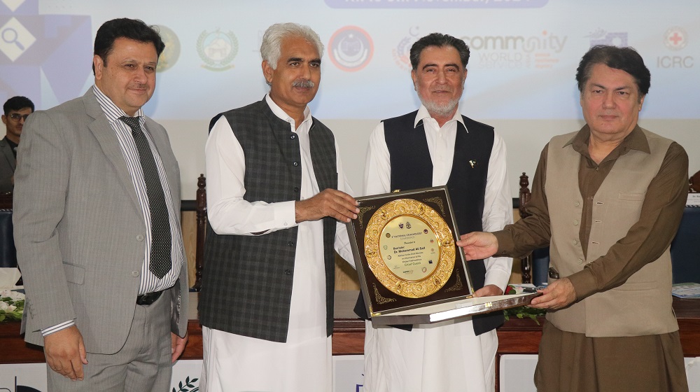 The chief guest , advisor to Chief Minister on Information and Public Relations, Barrister Muhammad Ali Saif is holding a souvenir shield at the conclusion of the third National Criminology Conference.