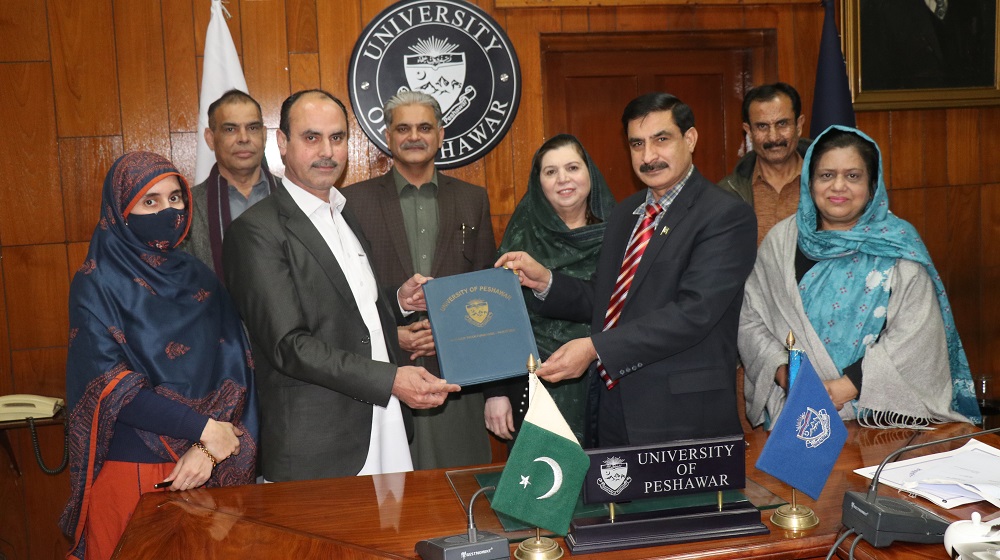 Vice Chancellor University of Peshawar Prof Dr Muhammad Idrees (Right) and Vice Chancellor, University of Swat Prof Dr. Hassan Sher (Left) shares MoU documents in the signing ceremony.