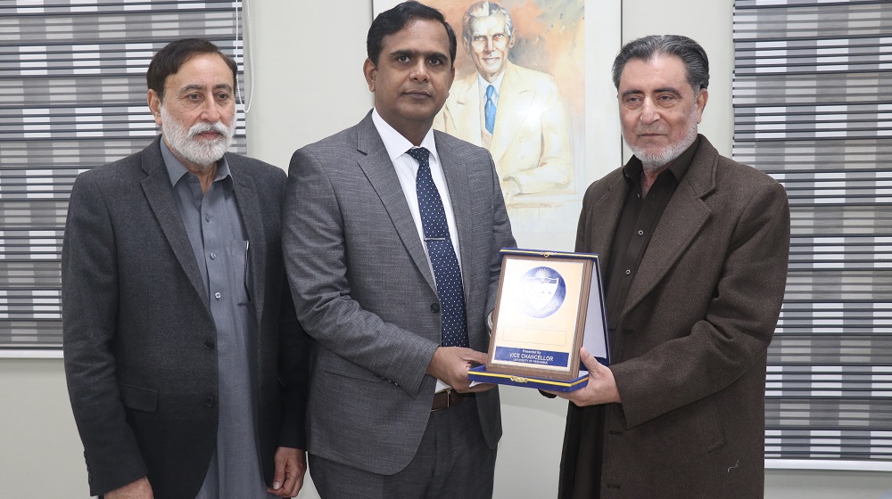 HEC - Director Sports and Co-curricular Activities Mr. Javed Ali Memon is receiving a shield from the worthy  vice chancellor just before the commencement of PCB-HEC inter-varsity Cricket Championship.