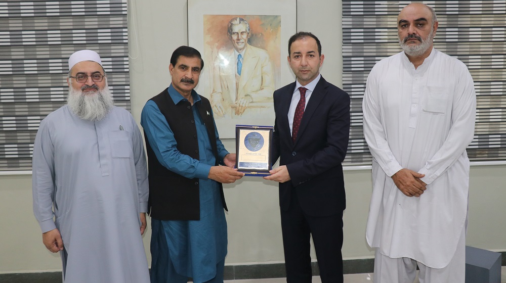Vice Chancellor Prof. Dr. Muhammad Idrees presents a souvenir to Mr Muhsin Balci, country head, Turkish Cooperation and  Coordination Agency (TIKA), Pakistan upon his visit to the University of Peshawar.